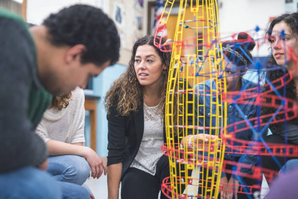istock Ethnic art teacher shows her class a colorful example of sculpture 928741240