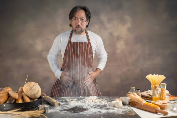 istock Chef hipster stylish kneads dough for bread on wooden board 928744026