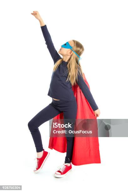 7 Or 8 Years Old Young Female Schoolgirl Child In Super Hero Costume Performing Happy And Excited Isolated On White Background In Leadership Success Courage And Fantasy Concept Stock Photo - Download Image Now