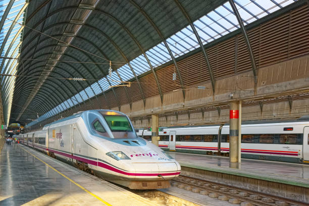 Modern hi-speed passenger train of Spanish railways company-Renfe, on Seville railways station Sevilla Santa Justa. Seville, Spain - June 10, 2017 : Modern hi-speed passenger train of Spanish railways company-Renfe, on Seville railways station Sevilla Santa Justa. seville port stock pictures, royalty-free photos & images