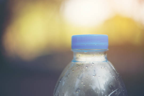 istock Water bottle with blurred nature background, copy space. 928759776