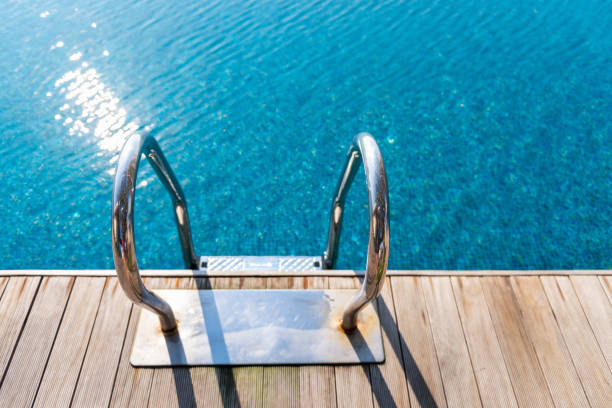 istock Grab bars ladder in swimming pool on the deck floor 928762600