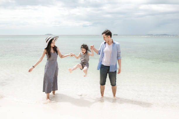 istock Young family having fun on beach. 928764830