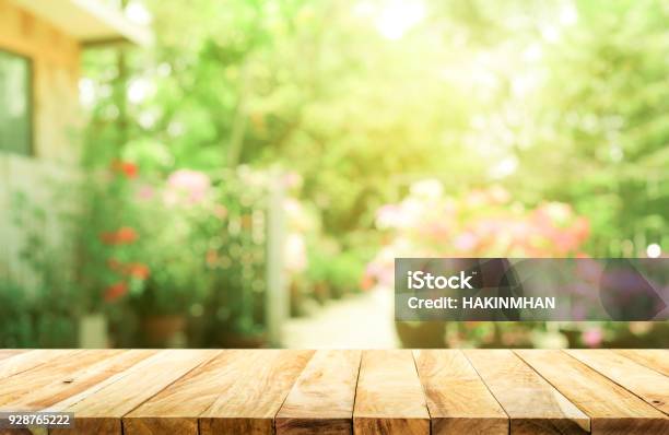 Empty Wood Table Top On Blur Abstract Green From Garden And House Background Stock Photo - Download Image Now