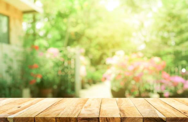 пустой деревянный верх стола на размытие абстрактный зеленый от сада и дома фон - показ сад стоковые фото и изображения