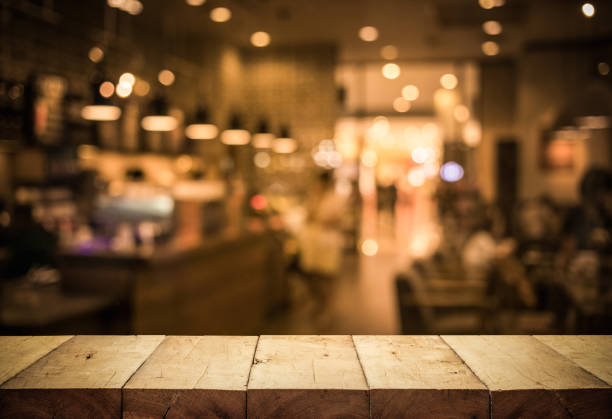 Wood table top (Bar) with blur light bokeh in dark night cafe,restaurant background Wood table top (Bar) with blur light bokeh in dark night cafe,restaurant background .Lifestyle and celebration concepts ideas food court photos stock pictures, royalty-free photos & images