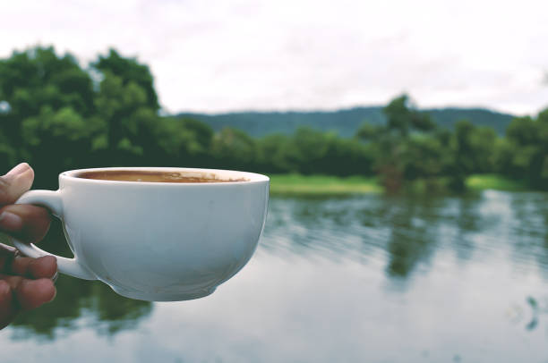 istock Good morning with coffee in white cup and nature view background. 928765604