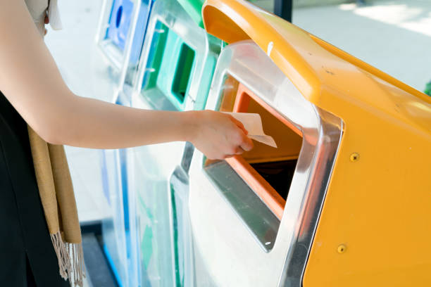 istock women hand throwing away the garbage to the bin/trash, sorting waste/garbage before drop to the bin 928771602