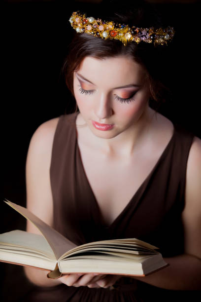 Young brunet girl with wreath and book