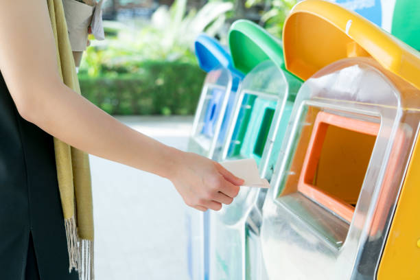 istock women hand throwing away the garbage to the bin/trash, sorting waste/garbage before drop to the bin 928772454