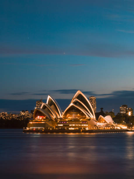 Sydney, Australia - February 5, 2018: Sydney Opera House view from North Sydney at night with blue sky.