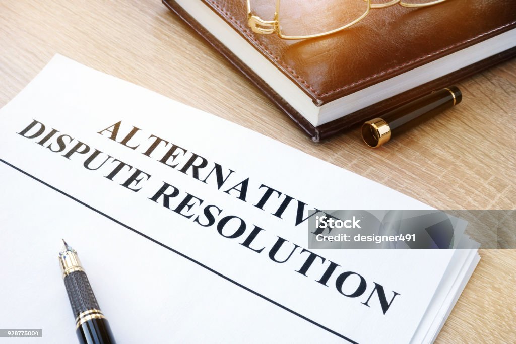 Documents with title alternative dispute resolution ADR in an office. Conflict Stock Photo