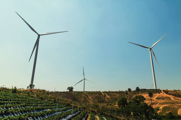 istock concept idea eco power energy. wind turbine on hill with sunset 928776294