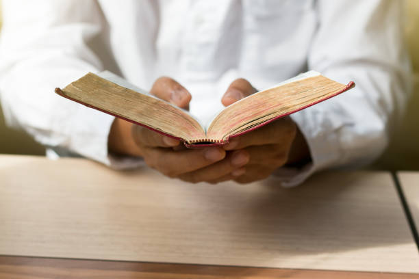 istock Women reading from the holy bible, close up 928780972