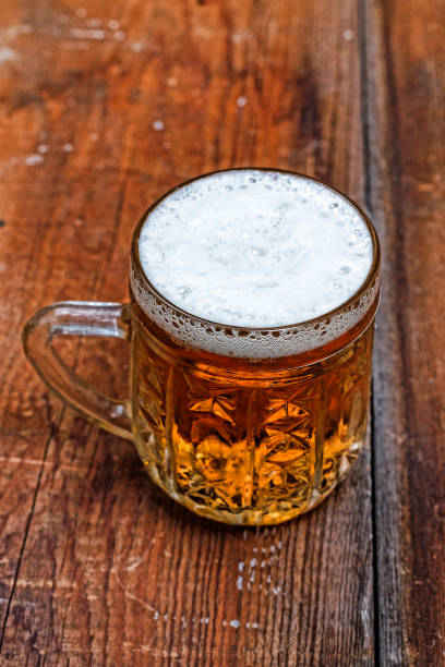 istock Mug, lager, beer, foam, wooden table, pub, Beer Fest, German b 928783202