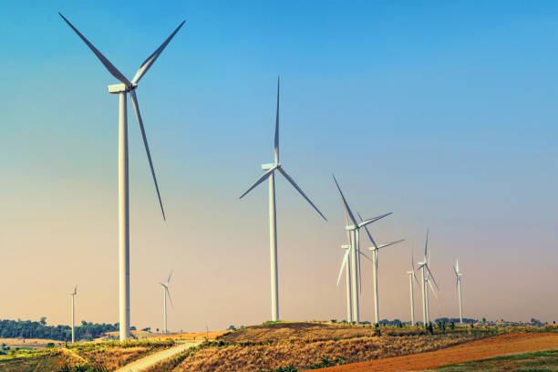 istock concept idea eco power energy. wind turbine on hill with sunset 928783692