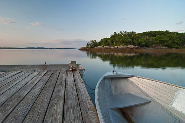istock Low view Row Boats Leaning against Dock on Still Water 92878975