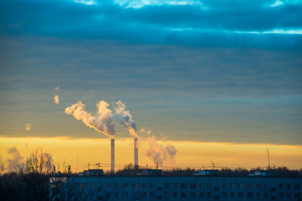 istock Smoking pipes of thermal power on sunrise 928790322