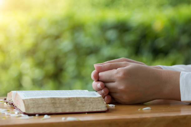 istock Women reading from the holy bible, close up 928790416