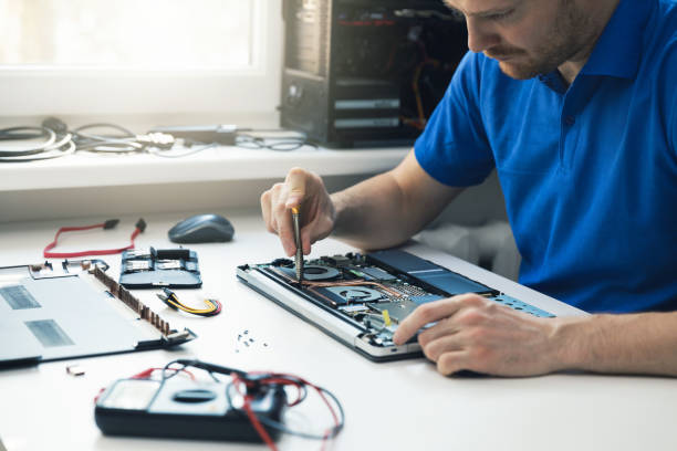 istock computer repair service - technician repairing broken laptop in office 928791078