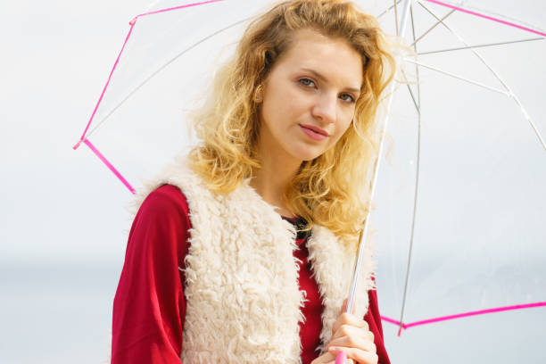 istock Woman having fun outdoor with umbrella 928791598