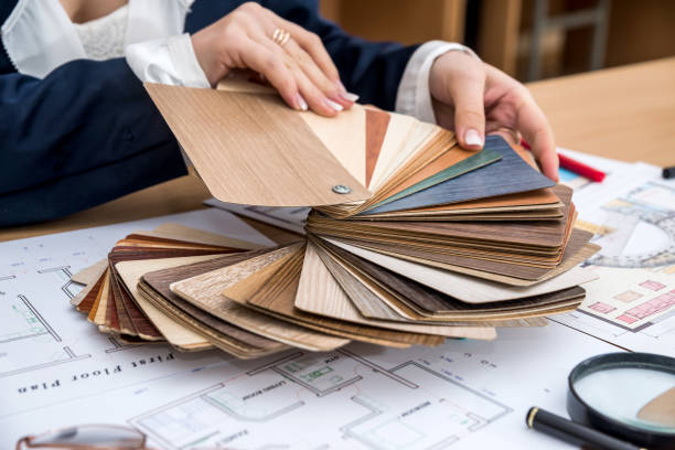 istock Woman chooses designer wood material for modern home 928794318