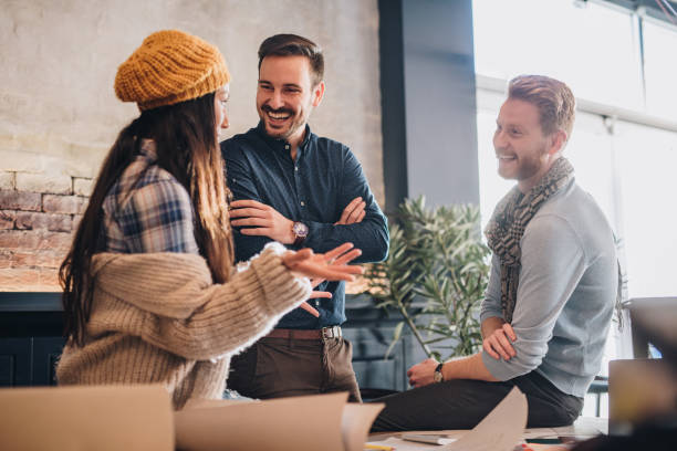 istock Young happy freelance workers communicating at casual office. 928797498