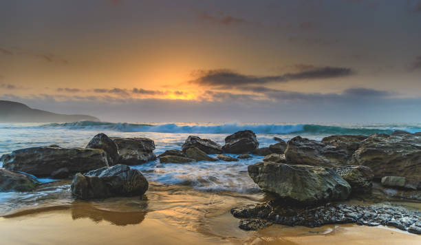 istock Hazy Sunrise Seascape with Rocks 928797774