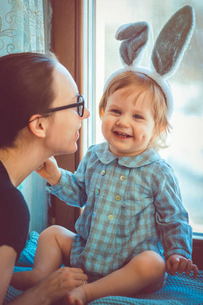 istock Baby with rabbit ears and his mother in Easter 928798154