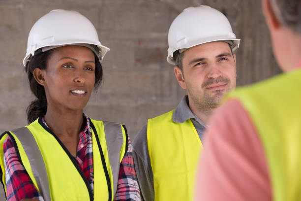 istock Building workers receive briefing from their chief contractor. 928798922