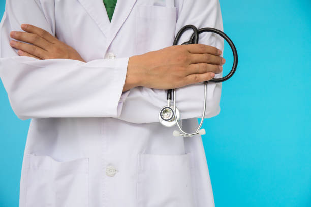 istock Doctor holding a stethoscope on white background 928799190