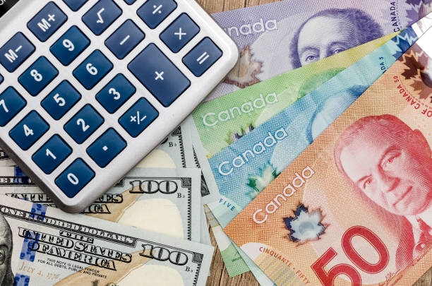 istock calculator with dollar usd and cad on desk 928799466