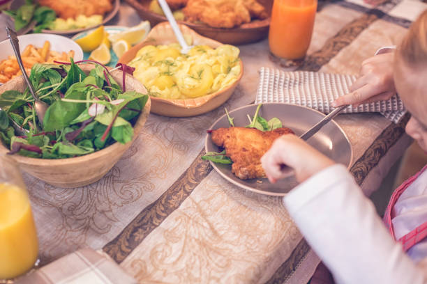 istock Eating Wiener Schnitzel with Potatoes and Green Salad 928802770