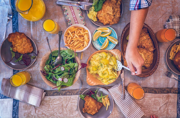 istock Eating Wiener Schnitzel with Potatoes and Green Salad 928802786