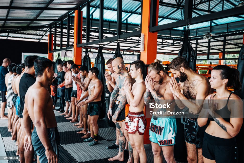 Muay Thai training is over Martial arts are physical activities good for both men and women, recreational athletes or professional fighters. Many people coming to Thailand to practice and improve their technique with experienced local Muay Thai and MMA trainers. Athletes geet each other after training Muay Thai Stock Photo