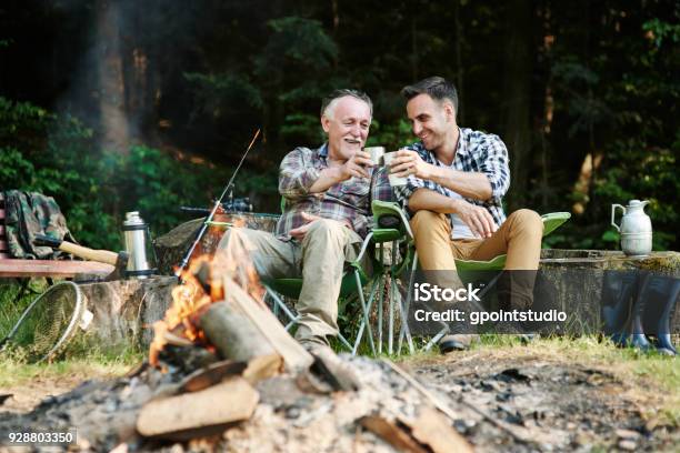 Fishermen Drinking Coffee Beside Bonfire Stock Photo - Download Image Now - Camping, Friendship, Father