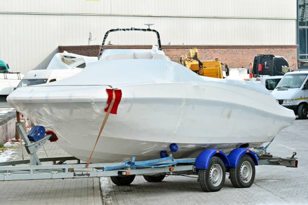 istock Modern boat in foil on a trailer for transportation 928803412