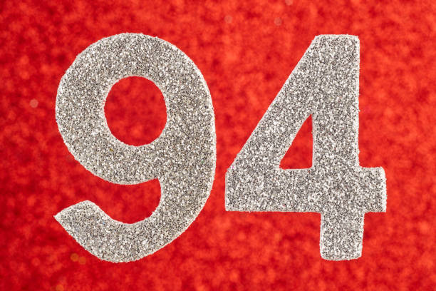 istock Number ninety-four silver color over a red background. Anniversary 928803844