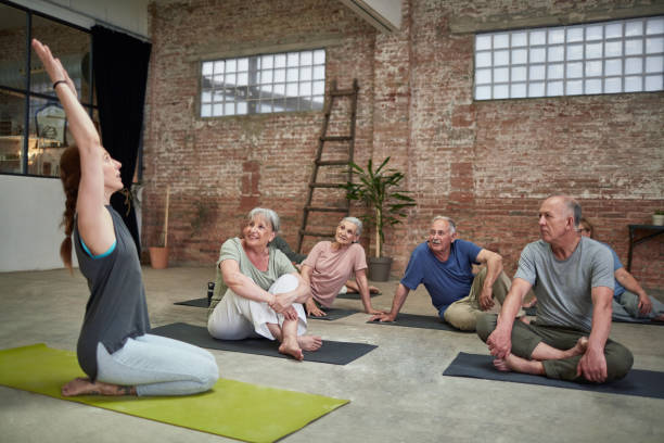 istock Instructor teaching smiling seniors at yoga class 928804466