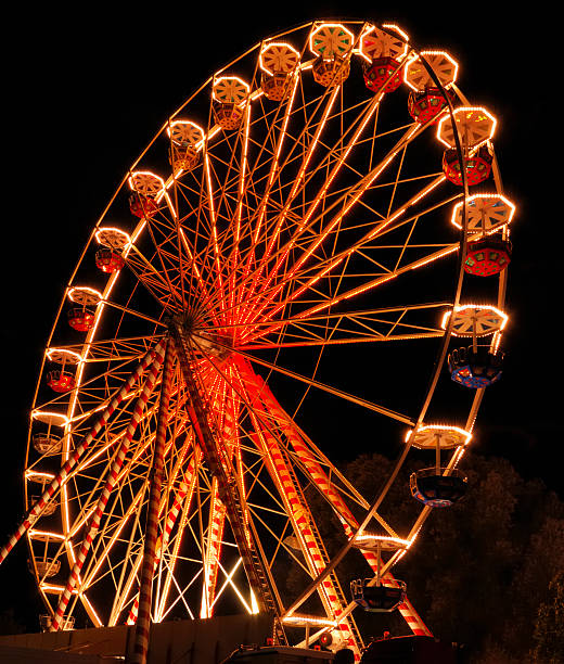 istock Large ferris wheel illuminated with orange light at night 92880472