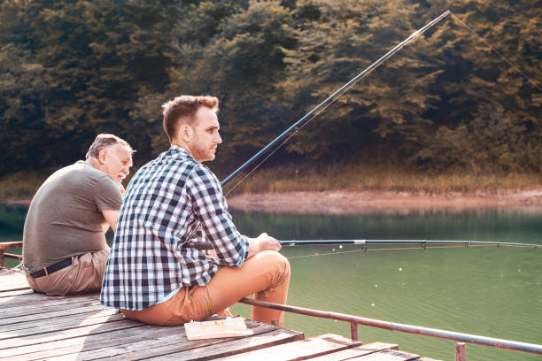 istock Father with son fishing on jetty 928806146