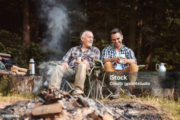 Two Fishermen Camping In Forest Stock Photo - Download Image Now - Camping, Father, Men