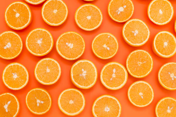 istock Background from the oranges cut in half on an orange background 928810080