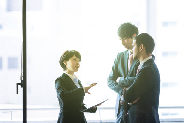 giovani imprenditori in ufficio. - three people group of people standing business person foto e immagini stock