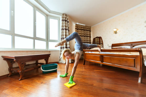 istock Housewife acrobat while cleaning. 928810702
