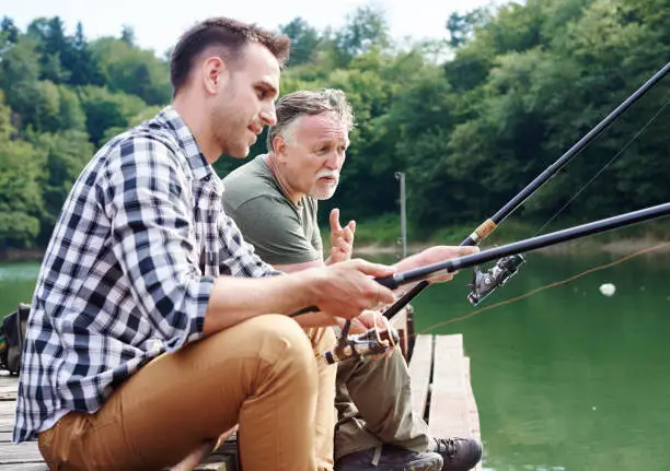 Photo of Men talking and fishing together