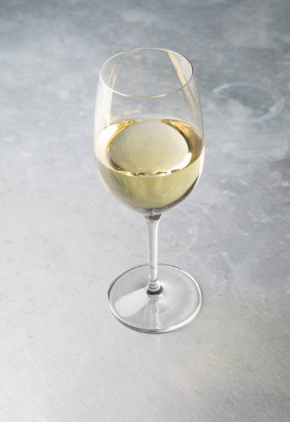 istock Glass of white wine on a bar counter 928823818