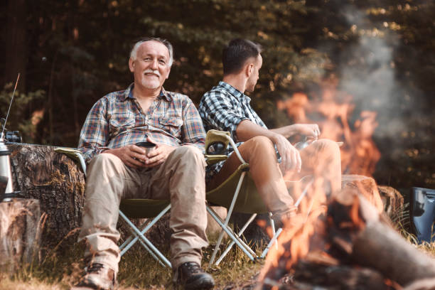 istock Camp with bonfire in woodland 928823884