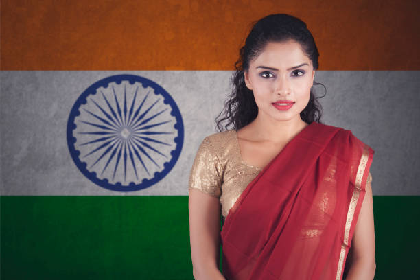 istock Confident Indian woman with saree posing over Indian flag 928826204