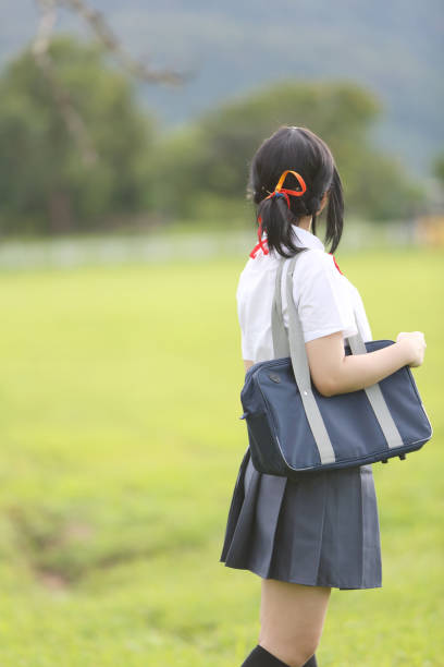 istock Japanese school in countryside with grass mountain and tree 928826622